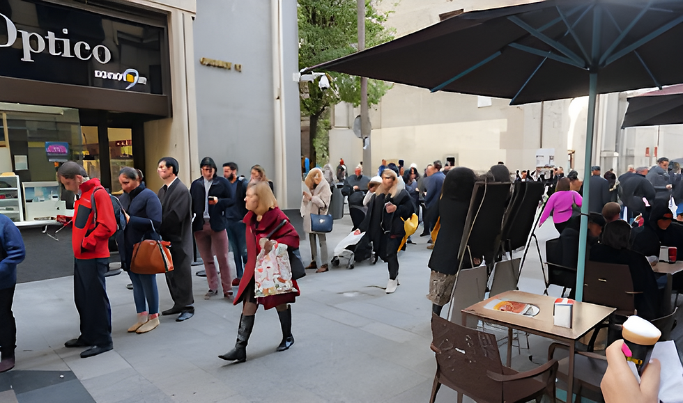People queue outside Optico store in line for lotto tickets on a Madrid sidewalk; many hold bags and drinks on this busy city street