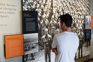 A  young Japanese man studies the sad story of the internment of thousands of innocent Japanese Americans at the Pearl Harbor Memorial