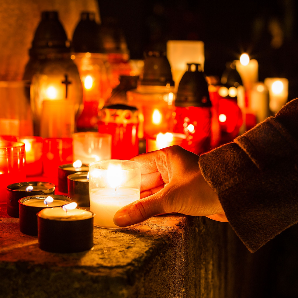 All Saints Day in a Barcelona cathedral involves candles and prayer for the dead.