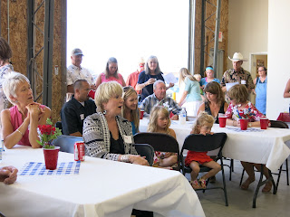 The Fire Hall was the place for the feast following the cemetery rituals, with more tributes here by a brother-in-law and grandson, and music: a group sing of "When Irish Eyes Are Smiling."