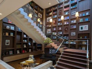 A stylish stairway in the lobby at Shiba Park Hotel showcases an extensive collection of books and a serene water feature. This welcomes travelers after a long flight and creates a tranquil atmosphere