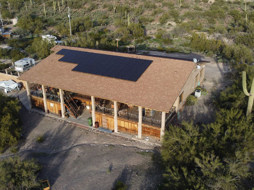 Aerial drone view of a Phoenix Valley Arizona home rooftop with solar panels showing the solar panel payback period for homeowners in Mesa Chandler Scottsdale and Gilbert
