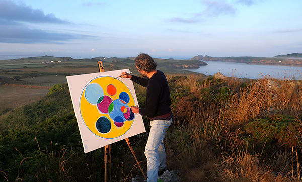 the artist dg painting at dawn on the coast near St Davids in Pembrokeshire
