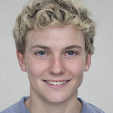 A college-age boy. Pale Caucasian, curly blond hair, blue eyes.