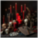red, black, gray, lots of candles, paint brushes, skulls, dried flowers, wooden paint pale