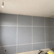 Acoustic plasterboard fitted over a wall soundproofing system
