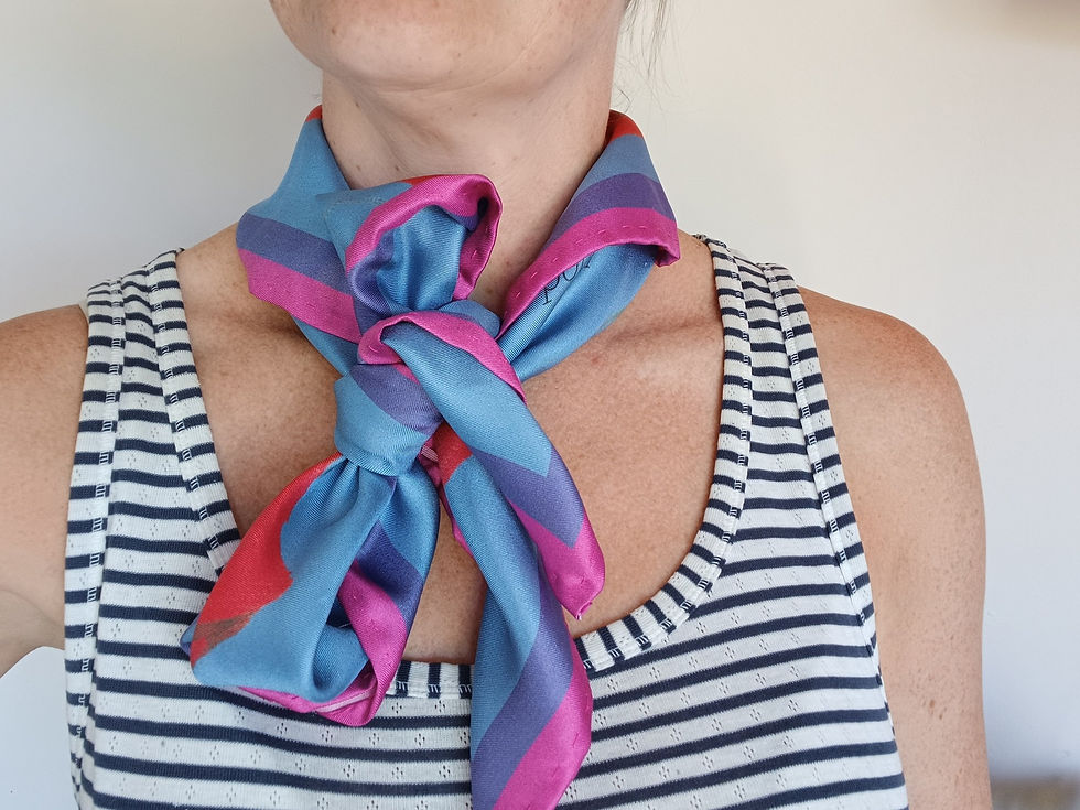 The Poppy silk twill scarf tied into a loose bow