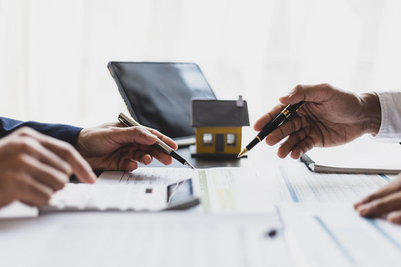 Two people looking over credit scores during a loan determination.