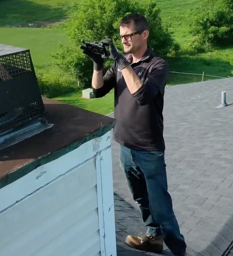 RoofCo professional performing hail damage roof inspection