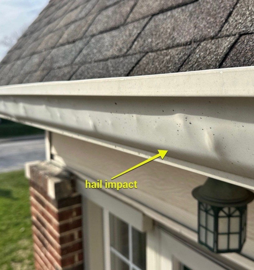 Hail damage marks on gutter