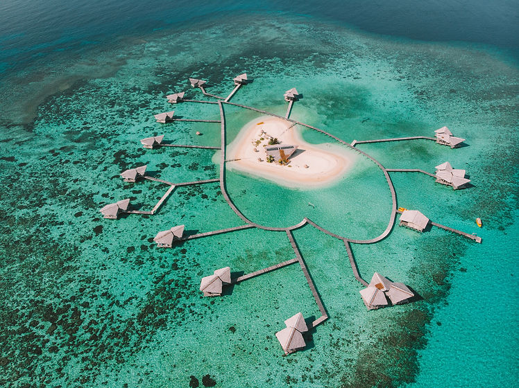 Aerial view of Pulo Cinta island, Indonesia. Eco house resort bungalow over the water.jpg