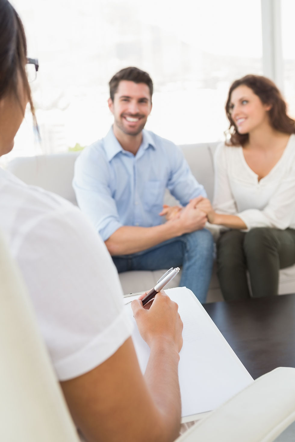 smiling-couple-speaking-with-their-therapist.jpg