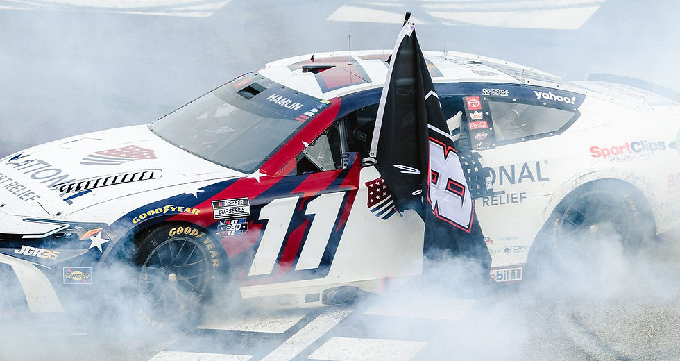 Denny Hamlin celebrates his win at Michigan by honoring the late Kyle Busch. (Photo: Hannah Tallant/NASCAR Digital Media)