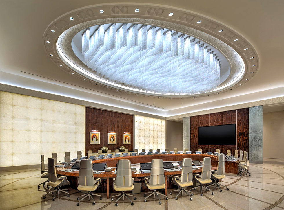 Grand conference room with oval table, screen, and impressive ceiling light.
