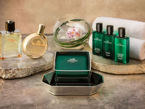Hermes spa products: toiletries, towels, perfumes, and orchid