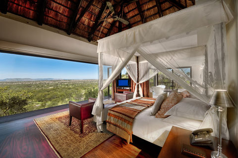 Guest room at Four Seasons Safari Lodge Serengeti, Tanzania, with views of the savannah and wildlife, blending luxury accommodation with an immersive safari experience.