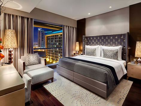 Modern luxury guest room at Lancaster Plaza Beirut hotel, Lebanon, featuring plush bedding, contemporary design, and floor-to-ceiling windows with stunning city views