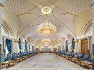Intricate gold ceiling and chandeliers in Qasr Al Watan