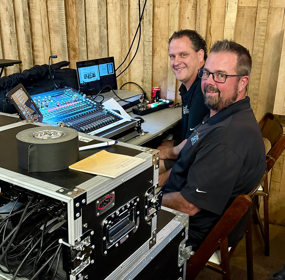 Men at a previous JICL community event running a sound setup.