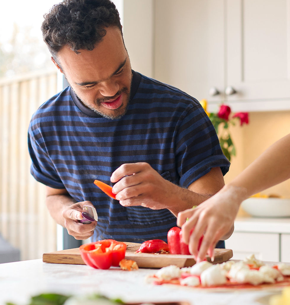 A person with disabilities cooking in his supported living home.