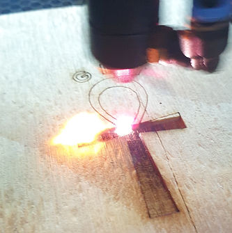 Laser engraving machine creating the GLM logo