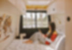 Woman relaxing in van, reading book by window