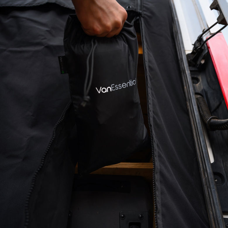 Person storing VanEssential bag in van