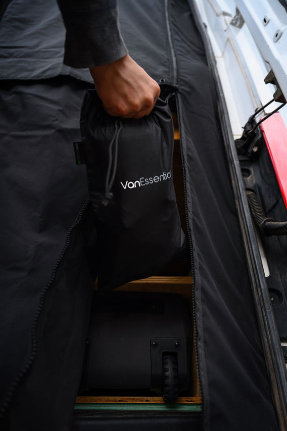 Person storing VanEssential bag in van
