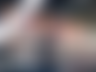 A person wearing a backpack stands in a busy airport, looking up at a large electronic departure board. The text "Avoid Mistakes When Booking International Flights" is overlaid on a purple diagonal banner in the upper left corner.