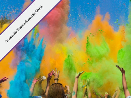Crowd of people celebrating by throwing vibrant colored powder into the air during a festival, with clouds of blue, yellow, green, orange, and pink filling the sky. Text overlay in the top left corner reads "Unmissable Festivals Around the World."
