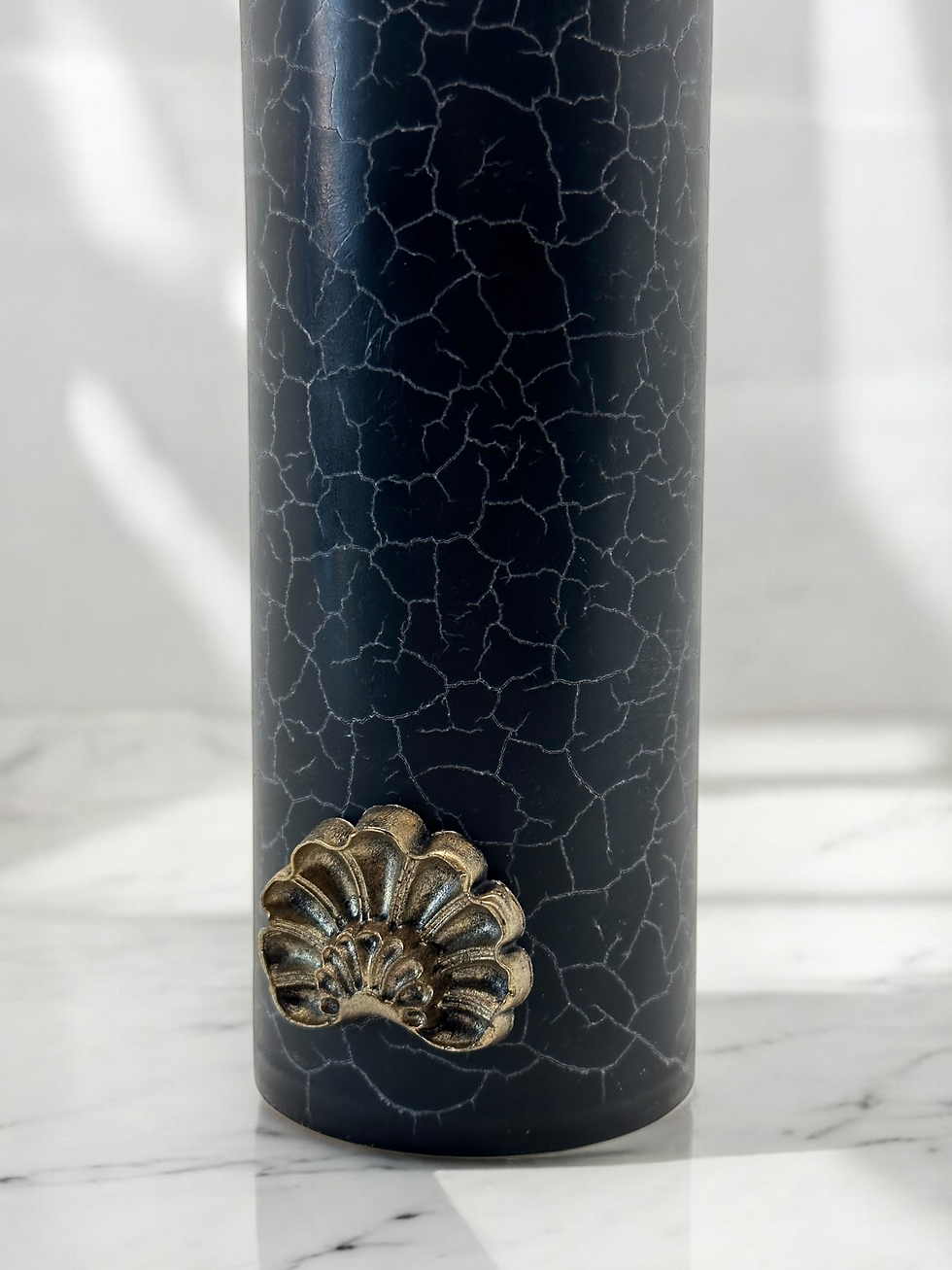 Handcrafted luxury candle. Design candle with black marbled surface. Cracked candle. Golden wax emblem. Soy wax candle.