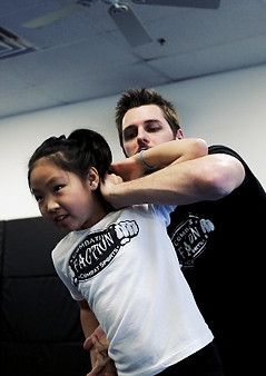 girl doing self defense in a kids mma class in mesa gilbert