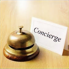 Brass service bell next to a Concierge sign