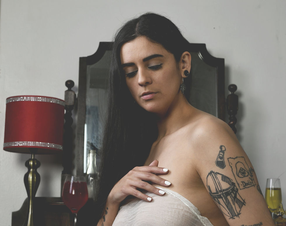 Misuzu in a bedroom setting wrapped in a white material