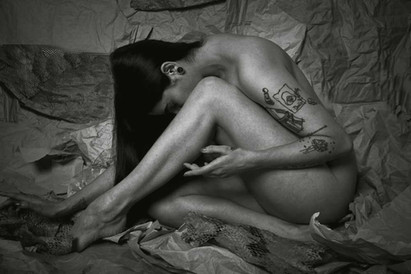 Monochrome implied nude of Misuzu posing classically on a paper set