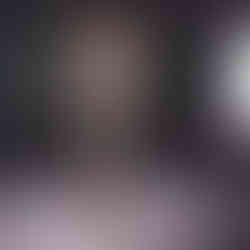 Misuzu standing in the cocoon body stocking with a studio light in frame