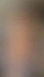 Misuzu nude, wearing a light open cardigan with a black and cream pattern