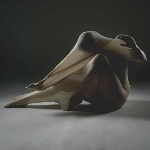 Misuzu seated in the cocoon body stocking