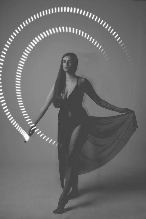 Monochrome of Misuzu in long black lingerie, taken on a long exposure with a circular light trail