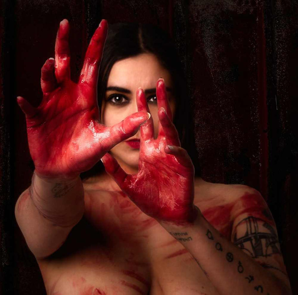 Misuzu covered in fake blood wit her hands in front of her face