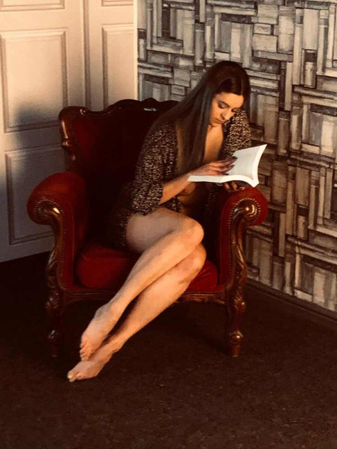 Misuzu reading the book ‘Life and Poems of a Lonely Princess’ by Kaneko Misuzu, in an armchair