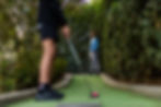two man playing putt putt golf