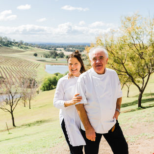 owners of bistro molines standing in alfresco dining area