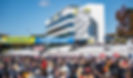 A large crowd of spectators in front of the Michelin Tower at Michelin Raceway Road Atlanta.