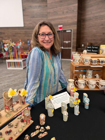 Susan poses with some of her wares at the 2025 ArtRageous Festival in Braselton