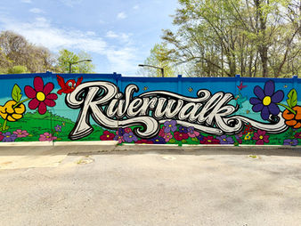 Riverwalk by Chris Hobe is a colorful mural that greets visitors in the parking area.