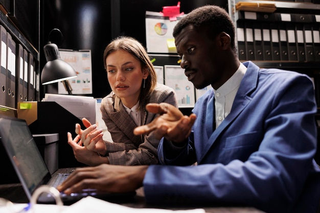 diverse-businesspeople-working-overhours-accountancy-report-analyzing-administrative-docum