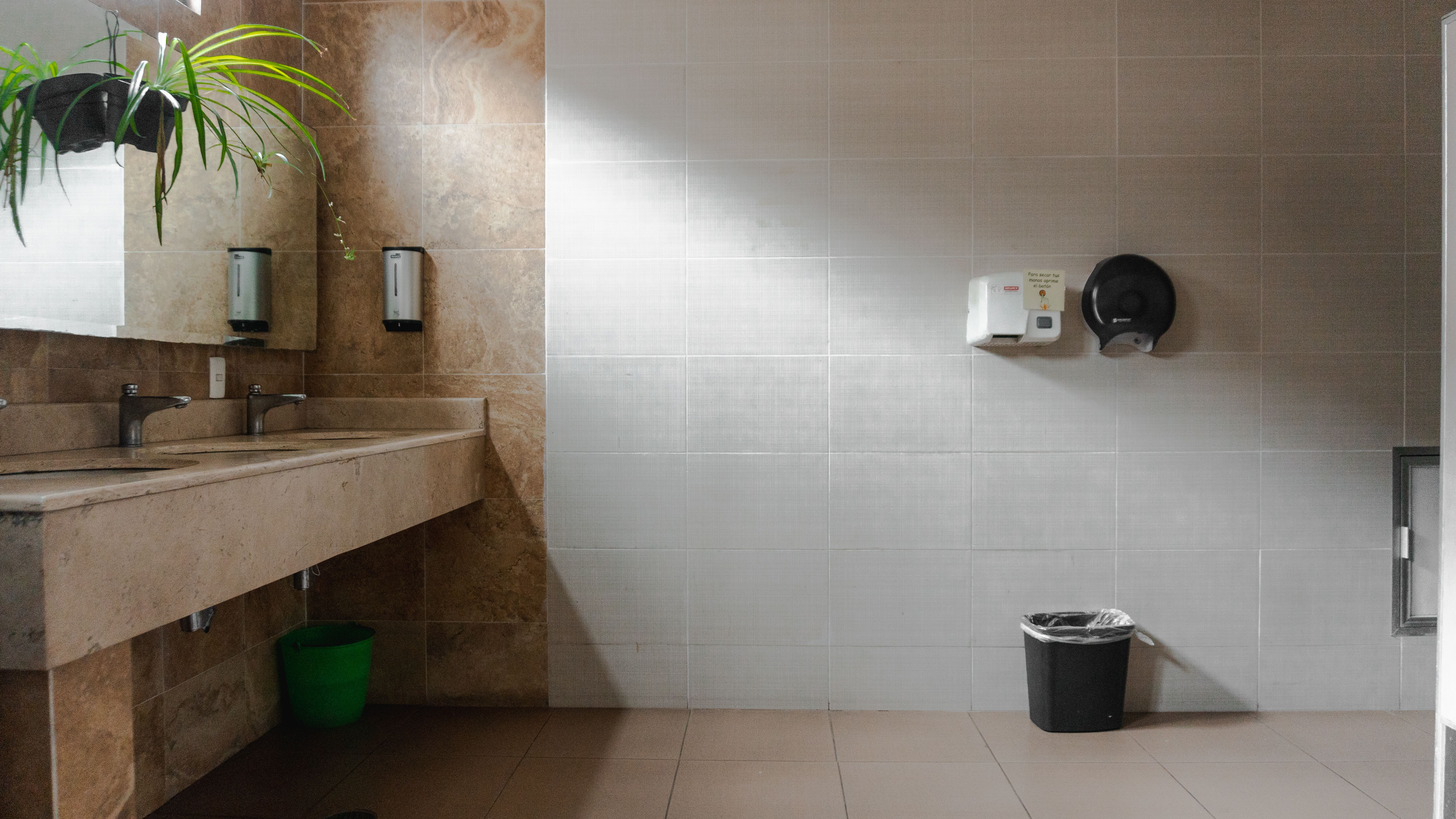 Commercial shared washroom with multiple sinks and hand dryer