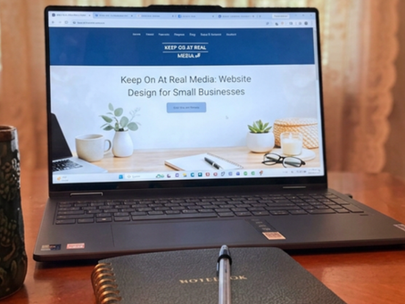 Human-centered workspace: Laptop, coffee mug, notebook and pen for buidling thoughtful Wix Studio websites for busy small business owners