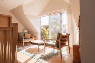 Light-filled sitting room overlooking the Surrey Hills landscape